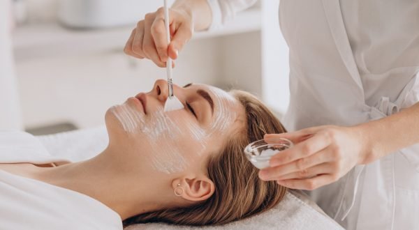 cosmetologist-doing-face-treatment-applying-face-mask
