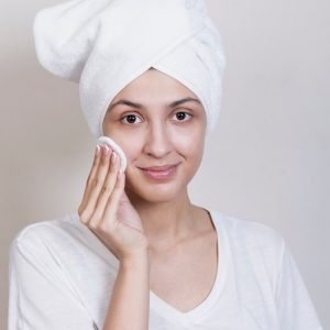 woman-looking-camera-cleaning-face_23-2148287304